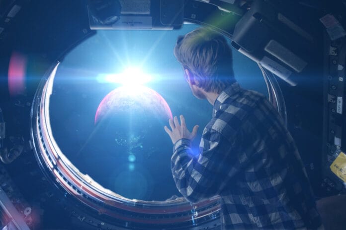 Person looking out from a spaceship window at Earth in space.