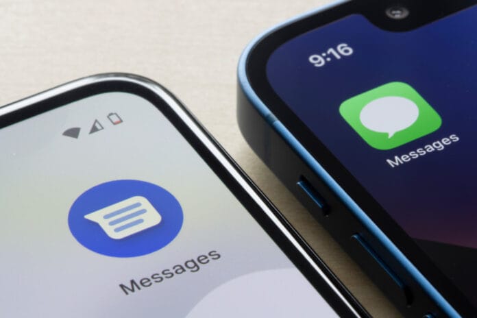 Close-up view of Android and Apple Messages app icons on two smartphones, highlighting cross-platform communication features.