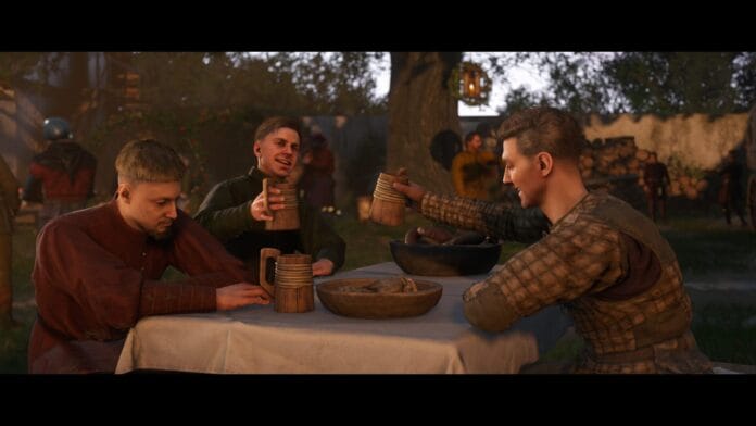 A detailed in-game screenshot from Kingdom Come: Deliverance II, showing three medieval characters enjoying a feast outdoors.