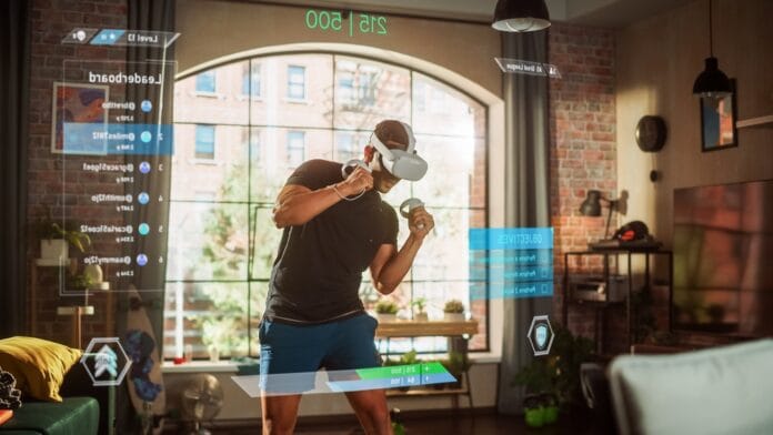 A man wearing a VR headset engaging in a gamified fitness workout in a modern living room setting.