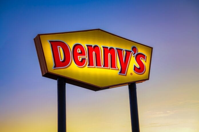 Denny’s restaurant sign glowing at dusk, representing the classic American diner chain.