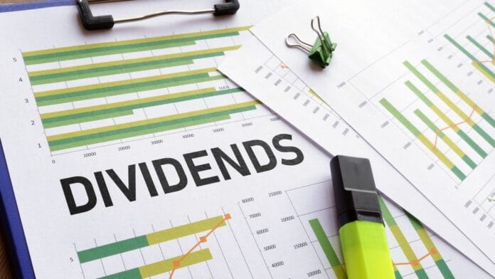 Financial documents with charts and the word “Dividends” highlighted, symbolizing dividend stock investments in 2025.